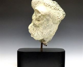 Nathan L. Fineberg, American, 20th century.  Carved Grey stone sculpture depicting a bearded man's face, on a Black painted wooden plinth.  Signed "Fineberg" and dated "1982" verso.  Plinth with slight wear and dents, small re-painted area towards bottom.  7 1/4 x 12 x 17 1/2" high overall. ESTIMATE $200-300
