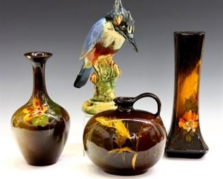 Four turn of the century Art Pottery vases.  Includes a Weller Aurelian vase with flared form and floral decoration, a Weller Louwelsa jug with ovoid shape and stalk of wheat decoration, a Weller Brighton kingfisher perched on a stump flower frog, and an unmarked vase with bulbous form and floral decoration.  Some surface wear overall with crazing, small flakes, and production glaze flaws, indentation at rim of Aurelian vase, 1/4" chip to rim of unmarked vase, bird with slight roughness at crest.  5 1/2 to 9" high.  ESTIMATE $300-500
