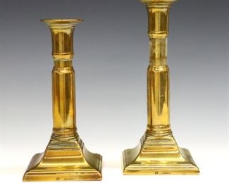 A pair of early 19th century Harrison Brass candlesticks.  Adjustable "telescopic" stems on square molded bases.  Impressed "H" and "Patent" at base.  Some wear and slight dents.  7" high, raise to 9 1/2" high.  ESTIMATE $100-150

