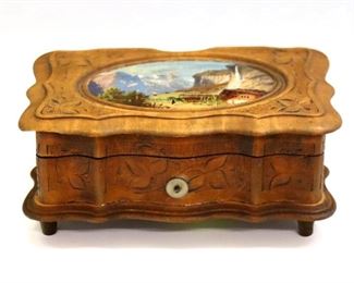 A turn of the century Swiss music box.  Carved softwood case with etched floral design and hand painted lid, original label lists 4 tunes "Bill Bailey", "Sweet Saturday Night", "When Mister Shakespeare (Comes to Town)" and "Floradora, I want to be a Military Man".  Case with wear and minor damage, lacks winding key.  6 1/4 x 4 x 2 1/2" high overall.  
