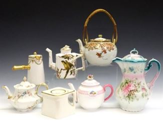 Seven 19th to early 20th century Japanese, French and British porcelain tea accessories.  Includes five teapots, a chocolate pot, and a hot milk pot.  Most with printed marks.  Various wear, crazing and minor damage, parrot design teapot with large flake and damaged finial at lid.  3 1/4 to 9" high.  ESTIMATE $300-400
