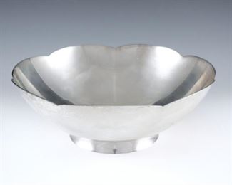 A Tiffany & Co Sterling Silver center bowl.  Simple footed form with scalloped rim.  Impressed "Tiffany & Co. Makers" and "Sterling" with "23843" pattern number.  20.36 troy ozs total weight.  Minor surface wear.  9" diameter x 3 1/4" high overall.  ESTIMATE $400-600
