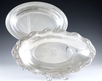 Two Sterling Silver oval serving dishes.  Includes a Gorham with simple banded rim, and a Reed & Barton "Tara" pattern with scrolled floral rim.  Each with maker's marks and "Sterling".  18.99 troy ozs total weight.  Minor surface wear, Reed & Barton monogrammed.  10 1/4" and 11 3/4" long.  ESTIMATE $400-600
