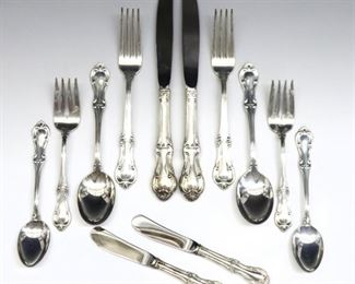 Ninety-two pieces of International Silver "Joan of Arc" pattern Sterling Silver flatware.  Features 12 six piece place settings plus additional spoons and serving utensils.  Includes 12 x 9 1/8" dinner knives, 12 x 5 3/4" butter knives, 24 x 5 3/4" teaspoons, 12 x 6 3/4" oval soup spoons, 12 x 6" salad forks, 12 x 7 1/4" dinner forks, and 8 x 4 1/2 to 9 1/8" specialty serving utensils.  Impressed "International Sterling" and "Joan of Arc".  90.09 total troy ozs plus 24 hollow handles, approximately 102.09 total weight.  Minor wear.  ESTIMATE $2,000-3,000
