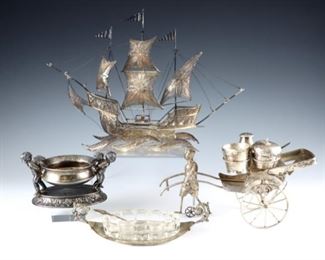 Four 19th and 20th century figural Silverplate pieces.  Includes a filigree model ship, a Chinese rickshaw form salt and pepper set, an American cherub salt cellar, and an Italian salt cellar with cut glass dish.  Some surface wear, discoloration and minor damage.  Up to 10" long and 7" high.  ESTIMATE $100-150
