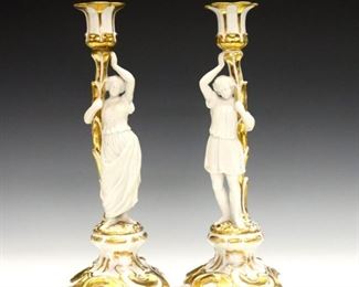 A pair of turn of the century French porcelain candlesticks.  Floral form with bisque figures and Gilded details.  Repairs to both candleholders, some wear to Gilt.  Each 12" high.  ESTIMATE $100-150
