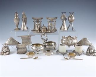 A Sterling Silver salt cellars and shakers lot.  Various traditional and figural forms including seven sets of Chinese export.  Sterling marked or tested.  16.45 troy ozs total weight.  Some wear and minor damage, small chips to glass liner, double cellar dented.  Up to 3" high.  ESTIMATE $400-600
