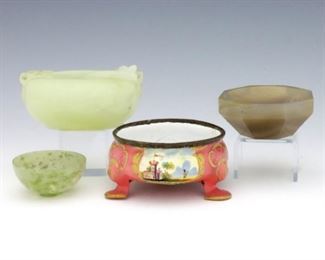 Four turn of the century Chinese and French salt cellars.  Various forms including three Chinese carved hardstone, and one French hand-painted enamel.  Octagonal Chinese salt with several small chips, hairline and damage to bowl, French salt with hairline cracks to enamel and oxidation to rim.  Up to 3" long.  ESTIMATE $200-300

