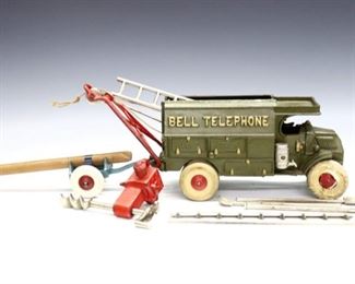 An early 20th century Hubley Cast Iron "Bell Telephone" repair truck.  Accessories include three shovels, two ladders, a crane lift, auger, and pole cart.  Impressed "Made in U.S.A" and "2011" at underside.  Minor wear to paint, tire rubber hardened and damaged, missing pulley hook.  9 x 4 x 5" high overall without accessories.  ESTIMATE $100-200
