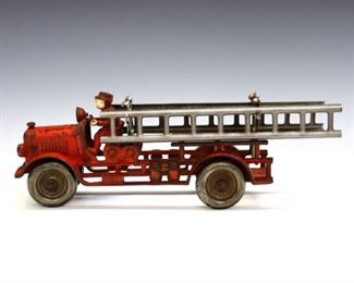 An early 20th century Hubley Cast Iron fire ladder truck.  Wear to paint, some rust, front ladder rack replaced.  9 x 4 x 5" high overall without accessories.  ESTIMATE $100-200
