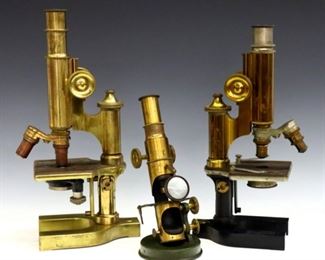 Three late 19th to early 20th century Brass and Cast Iron microscopes.  Includes two by Bausch & Lomb Co., serial #45066 and #41230, each with two objective lenses and U-shaped bases, and an unmarked field microscope with single lens and round base.  All having adjustable tubes and tilting frames.  Surface wear and discoloration to patina, tallest with "MSC ZOOL" incised at front of tube, two lacking sub-stage mirrors.  8 3/4 to 13" high.  
