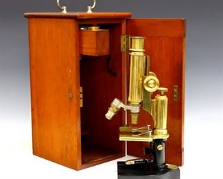 A cased early 20th century Brass and Cast Iron Bausch & Lomb Co. microscope.  Serial #27927 with adjustable tube, two objective lenses, and tilting frame on a U-shaped base.  Dovetailed Mahogany case with one fitted drawer holding two Brass lens cases and additional eyepiece.  Minor wear and scratches to Brass, case cracked at back, lens storage holding three small parts.  11 1/2" high, case is 6 1/2 x 7 3/4 x 14" high overall.  ESTIMATE $200-300

