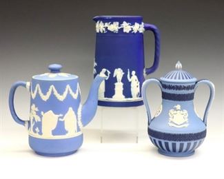Three pieces of 20th century Wedgwood.  Jasper dipped bodies with vintage garlands and classical figures in White relief.  Includes an early Royal Blue pitcher, an early Light Blue "Adams" tea pot, and a later Light/Portland Blue "Cutlers" covered vase.  Impressed marks.  Minor surface wear, slight paint loss at pitcher rim, teapot spout with production flaw and two small flakes.  Up to 7 1/2" high.  ESTIMATE $300-400
