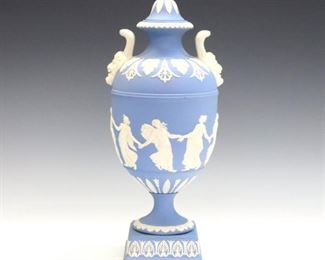 A late 20th century Wedgwood covered urn.  Light Blue Jasper dipped body with vintage garlands and classical figures in White relief.  Impressed marks.  Minor wear.  11" high.  ESTIMATE $200-400

