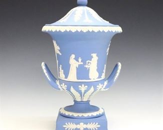 A late 20th century Wedgwood covered urn.  Light Blue Jasper dipped body with vintage garlands and classical figures in White relief.  Impressed marks.  Minor wear.  12" high.  ESTIMATE $200-400
