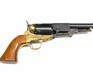 An Uberti replica Navy Arms black powder revolver.  .44 caliber, 6 shot, smoothbore 4 7/8" round barrel, with a walnut grip and Brass frame.  Serial #74434 with impressed "434" at top of frame, "Navy Arms Co. Ridgefield, New Jersey", "Black Powder Only - Made in Italy" and "Cal. 44" on barrel, with standard Italian "PN" and "star & shield" proof marks on frame, barrel and cylinder, with "AA" indicating 1975 manufacture date on frame above trigger guard, and Red Replica Arms logo on frame.  Some wear overall, Brass frame and trigger guard tarnished, minor wear to bluing, mechanism functions.  10 1/2" long.  ESTIMATE $100-200
