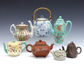 Seven 19th and 20th century Chinese teapots.  Various forms and designs in porcelain and earthenware, includes one with basket handle, three with polychrome bird/floral decoration, and three with matte finish.  Printed and impressed marks.  Some surface wear, minor damage to several lids.  3 to 8" high.  ESTIMATE $300-400 