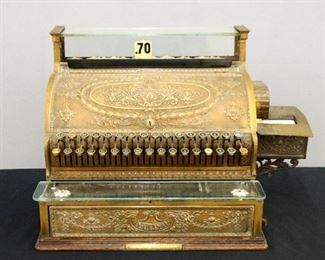 An early 20th century Brass National cash register.  Model 356-G, registers to $20 with cast Brass exterior plates, side mounted printer, lower drawer and Oak base.  Working with some wear, replaced glass till shelf.  19 1/2 x 16 1/2 x 17" high overall.  ESTIMATE $400-600