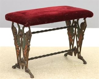 A 1930's Cast Iron radio bench.  Fancy filigree ends with winged figures and original multicolor painted finish.  Some wear, seat with older reupholstery.  12 x 23 x 17 1/2" high.  ESTIMATE $100-150