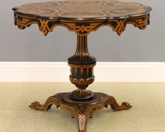 An early 19th century Venetian Marquetry center table.  Lobed circular top with intricate marquetry panels depicting rural Italian life on a conforming apron with geometric parquetry inlay, pedestal base with urn shaped stem and flattened tripod base.  Restored finish with losses and older repairs, shrinkage cracks in top, veneer damage.  Approximately 36" diameter x 31" high overall.   ESTIMATE $1,000-1,500