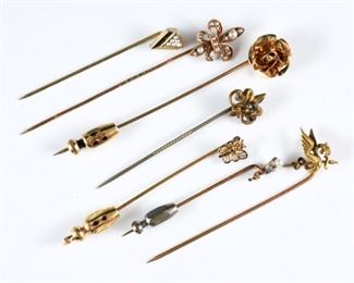 Seven 14k and 10k Gold lapel pins.  Various forms including five of 10k Gold with a rose, butterfly, two fleur-de-lis, and diamond form pins, with two of 14k Gold with dragon and flower form pins.  Several with small Diamond, Pearl and semi-precious stone accents.  Each marked or tested.  12.1 grams total weight.  Minor surface wear, larger fleur-de-lis missing one pearl, four lack clasps.  Up to 3" long.  ESTIMATE $400-600