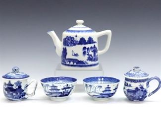 A Chinese Blue & White porcelain tea set for two.  Includes a teapot, covered creamer and sugar, and two tea cups, with hand-painted Blue pagoda and landscape decoration.  Minor wear to decoration, creamer and sugar with several firing cracks from production, cups and teapot lid rims with tiny chips.  Up to 5 1/2" high.  ESTIMATE $100-200