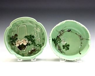 Two Chinese Celadon porcelain bowls.  Round forms with textured bodies and ruffled rims.  Hand-painted relief decoration depicts a mountainous landscape with crab and characters on one, and cherry blossoms on the other.  Impressed mark to one.  Minor wear.  Up to 7" diameter.  ESTIMATE $100-200