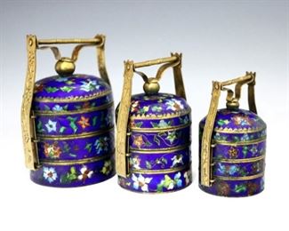 A set of Chinese Cloisonne stacking spice boxes.  Basket form with three tiers, multicolor floral decoration and etched Brass handles.  Some surface wear, minor loss to decoration.  2" to 3 1/2" high.  ESTIMATE $100-200
