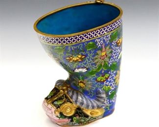 A large Chinese Cloisonne stirrup cup.  Buffalo head form foot with a cast lion at rim, multicolor floral decoration and Gilded detail.  Slight surface wear, minor loss to decoration.  6 1/2 x 4 1/4 x 8" high overall.  ESTIMATE $300-400