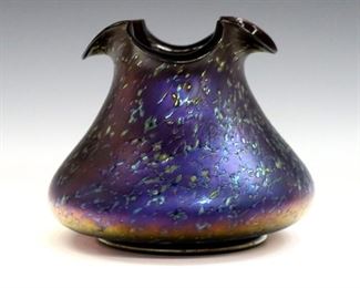 An early 20th century Kralik Art Glass vase.  Footed bell form with ruffled rim in Amethyst glass with iridescent textured finish.  Slight wear.  5 3/4" high.  ESTIMATE $200-300