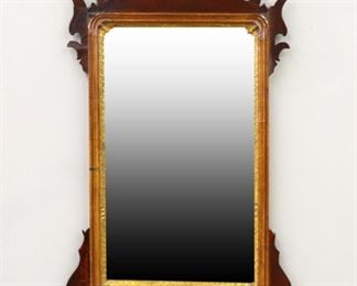 A 19th century Chippendale style wall mirror.  Scrolled Mahogany frame with inlaid crown detail, gilded inner molding and shaped beveled mirror.  Refinished with some restoration.  20 x 34 1/2" high.  ESTIMATE $100-150