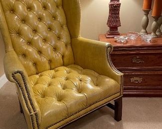 Faux leather tufted wing back chair 