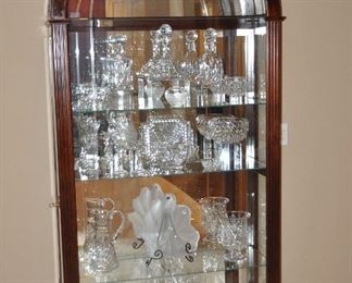 Howard Miller Arched Top Cherry Wood and Cut Glass Fronts Curio Display  Cabinet. Interior is Illuminated with 4 Adjustable Glass Shelves and a Mirrored Back and Base. 41" x 81"