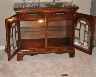 Interior of the cabinet is complete with 2 Drawers, a Glass Shelf and an Interior Light!