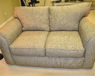 Two Cushion Upholstered Loveseat, in a Black and cream Multi-Colored Fleck Fabric, 64" w x 40"d x 38"h 