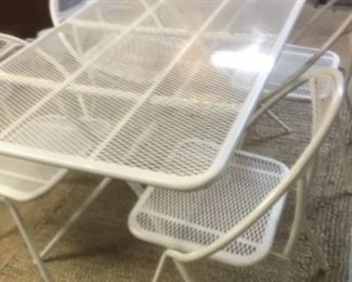 Metal patio table (52 by 30")and four matching folding chairs. Like new.