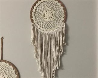 PRICE - $125; Close-up of crocheted wall hangings. 