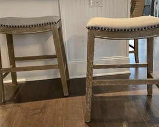 PRICE - $250/each; Pair Homeline counter-height upholstered wood and nailed bar stools. 