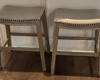 PRICE - $250/each; Pair Homeline counter-height upholstered wood and nailed bar stools. 