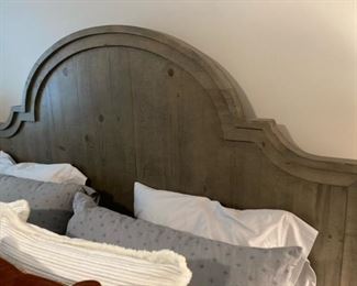 PRICE - $1,500; Universal king bed with distressed gray scalloped wooden headboard and footboard; includes mattress set. (Bed linens not included.)