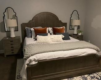 PRICE - $1,500; Universal king bed with distressed gray scalloped wooden headboard and footboard; includes mattress set. (Bed linens not included.)