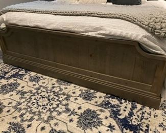 PRICE - $1,500; Universal king bed's distressed gray wooden footboard; includes mattress set. (Bed linens and rug not included in sale.)
