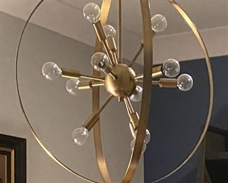 PRICE - $750; Exquisite Living's gold spiral orb brass chandelier.