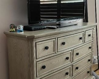 PRICE - $550; Haverty's distressed 9-drawer bachelor's chest/dresser (TV not in the sale). 