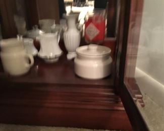 Miscellaneous items in small glass front cabinet in living room