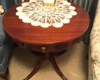 Round mahogany pedestal table in living room 