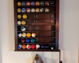 A set of balls come with the table, setup rack, brush. Cue ball wall rack.