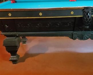 Carved accents all around the pool table.