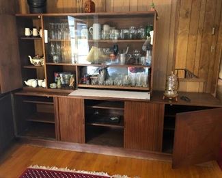Mid-Century Bar/Hutch measures 96"W x 20"D x 27"H.  Top piece is 66"W x 15"D x 36"H. made of glass and wood. Uniquely designed sliding doors. 60's style standing ice bucket included