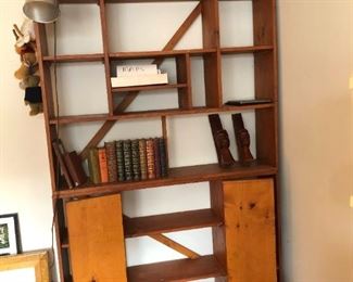 Two piece bookcase. Bottom has three shelves, Butterfly shelves in the middle. Bottom bookcase measure 50"W x 12"D x 36"H.  Top bookcase is also 50"W and 12"D, but stands 54"H (it has 4 additional shelves)